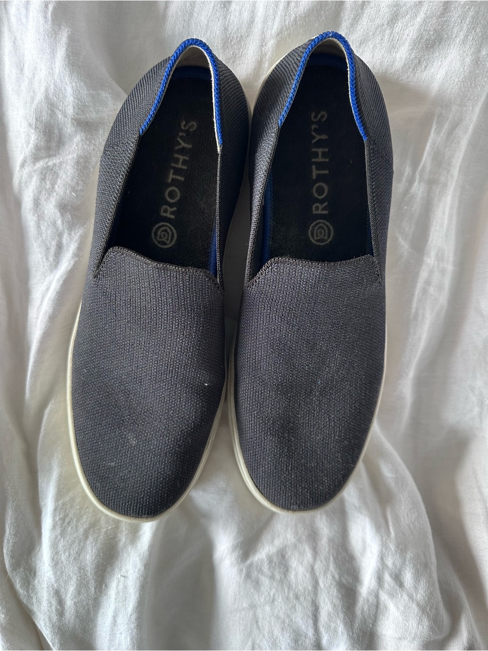 Rothy's Black Slip-On Flats with Blue Trim